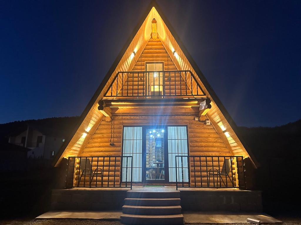 a wooden house with a staircase leading to a door at Borjomi-sadgeri comfort in Borjomi