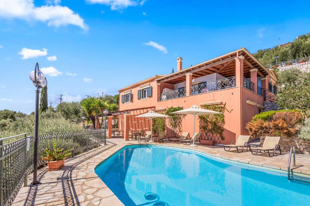 a villa with a swimming pool and a house at Villa Nefeli in Nisakion