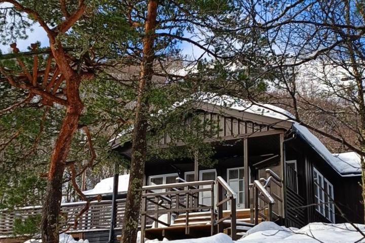 a cabin with snow on the roof of it at Cozy cabin in the Gilja paradise in Frafjord