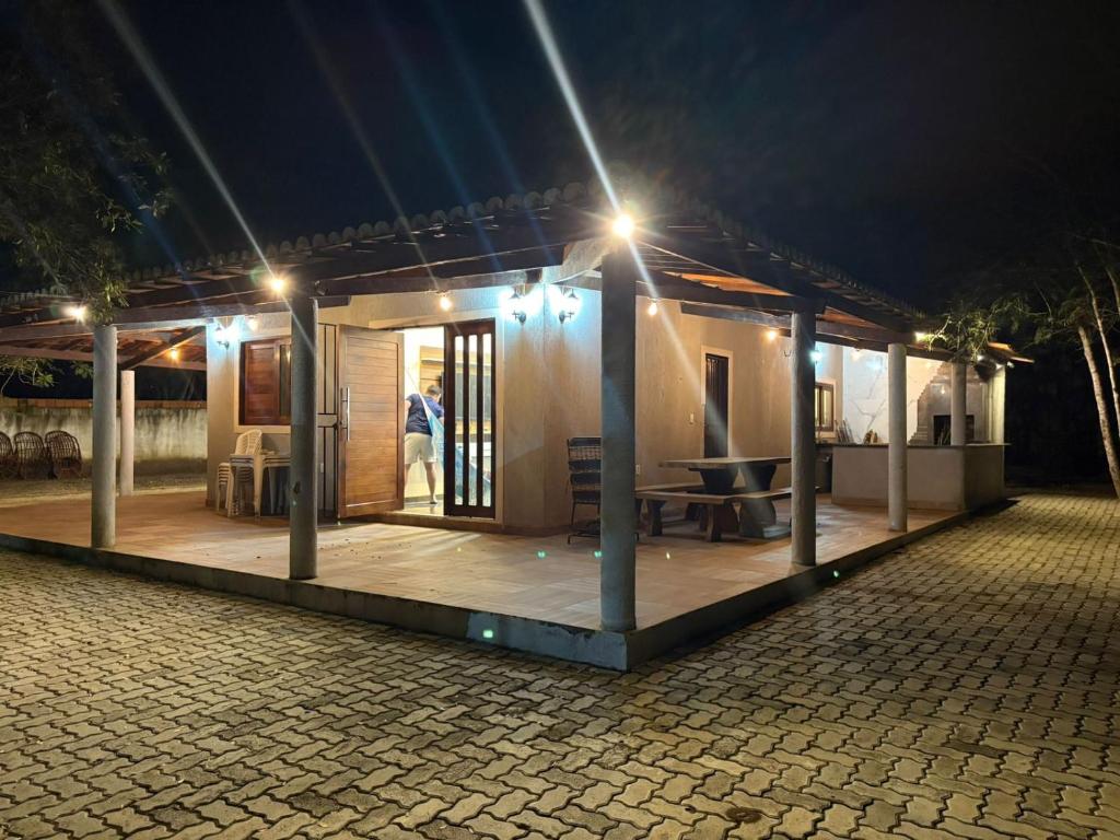 a small house with a porch at night at Casa na serra do Araripe in Crato