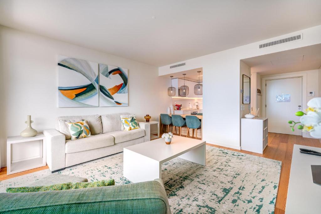 a living room with a couch and a table at Cond Bayline - Safia - Pool - SPA - Beach - GYM - BY BEDZY in Armação de Pêra