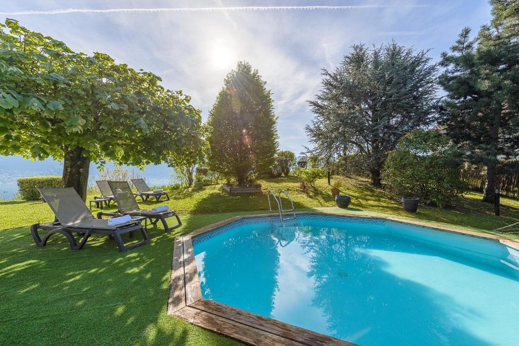 a swimming pool in the yard of a house at Villa Alizé - Demeure familiale avec Piscine et Vue Panoramique in Sévrier