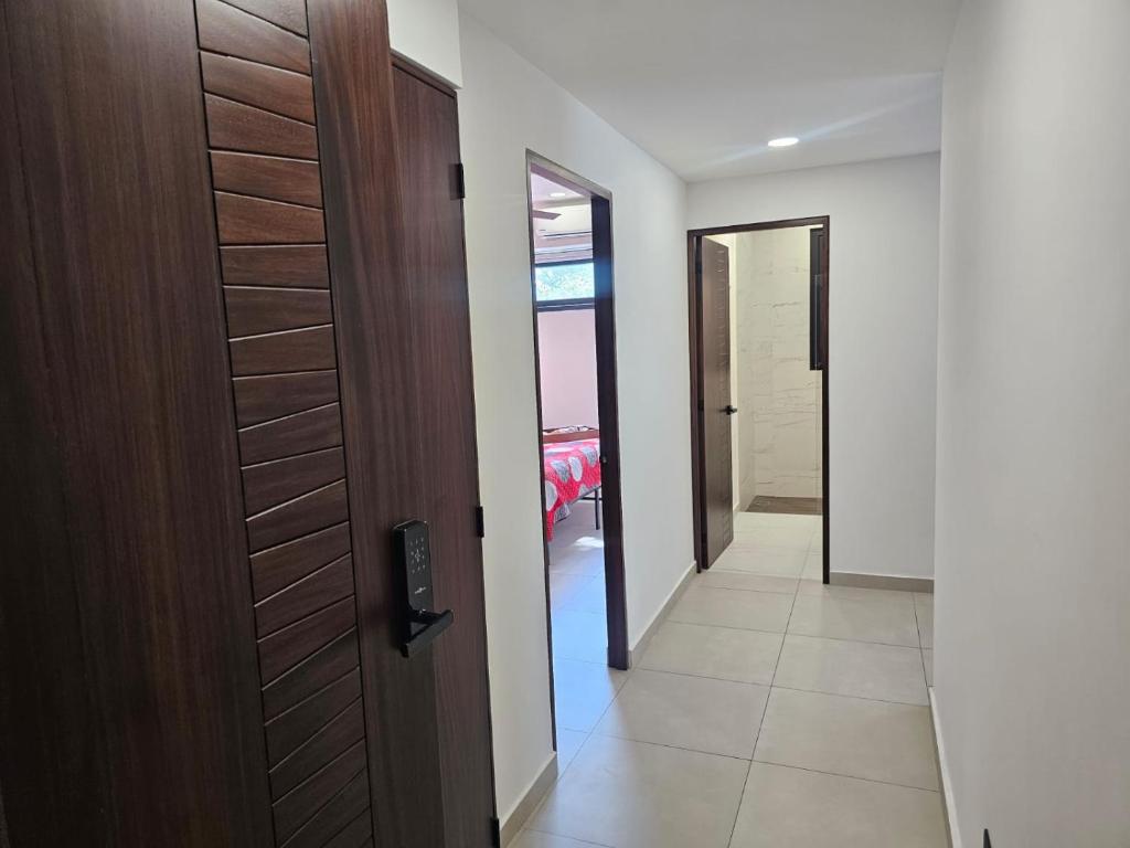 a hallway with a wooden door and a room at Central Studio with Roof Top Romantic Zone 202 in Puerto Vallarta