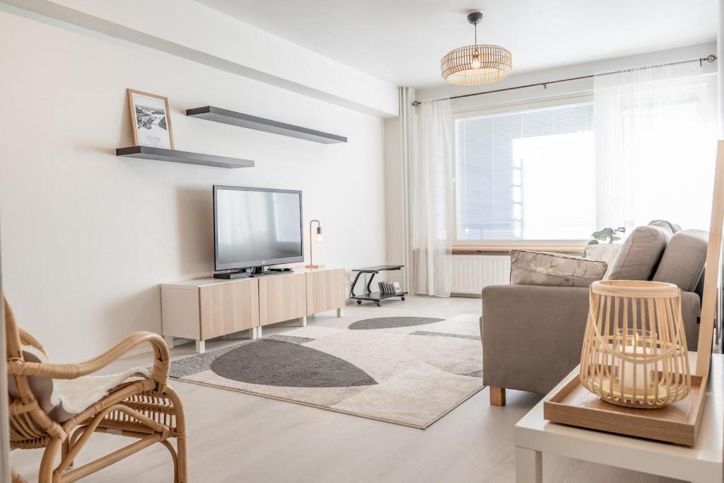 a living room with a television and a couch at Downtown Rovaniemi, Perfect Location in Rovaniemi