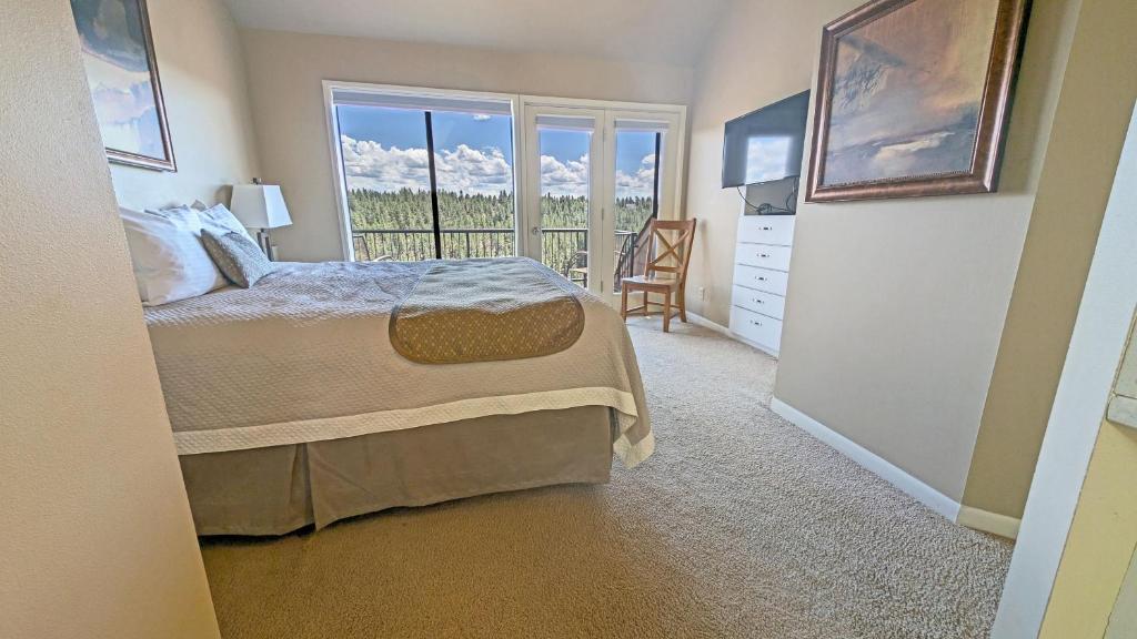 a bedroom with a bed and a window with a view at River Ridge 423AB condo in Bend