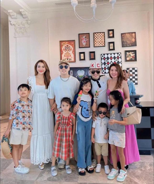 a family posing for a picture in a room at Villa NovaWorld Phan Thiết garden view, 3 BR for 6-8pax in Bình Tú