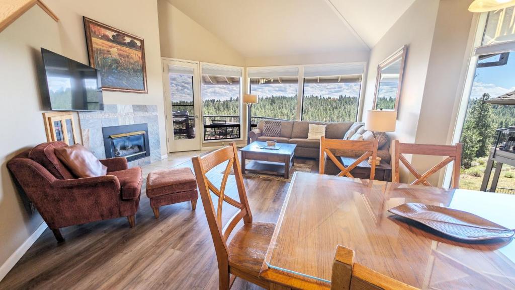a living room with a table and chairs and a fireplace at River Ridge 423A condo in Bend