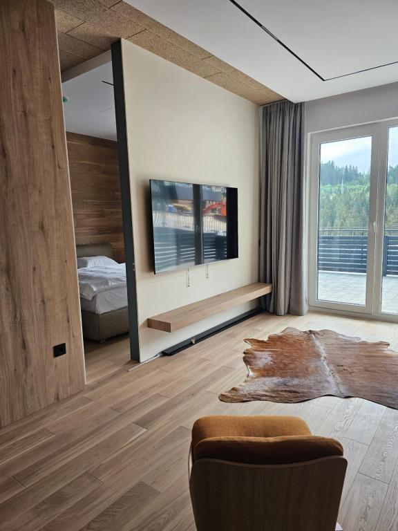 a bedroom with a bed and a tv in it at Vucko A 07 in Jahorina