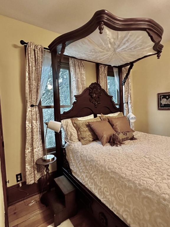 a bedroom with a large bed with a canopy at The Rest Is History in Baraboo