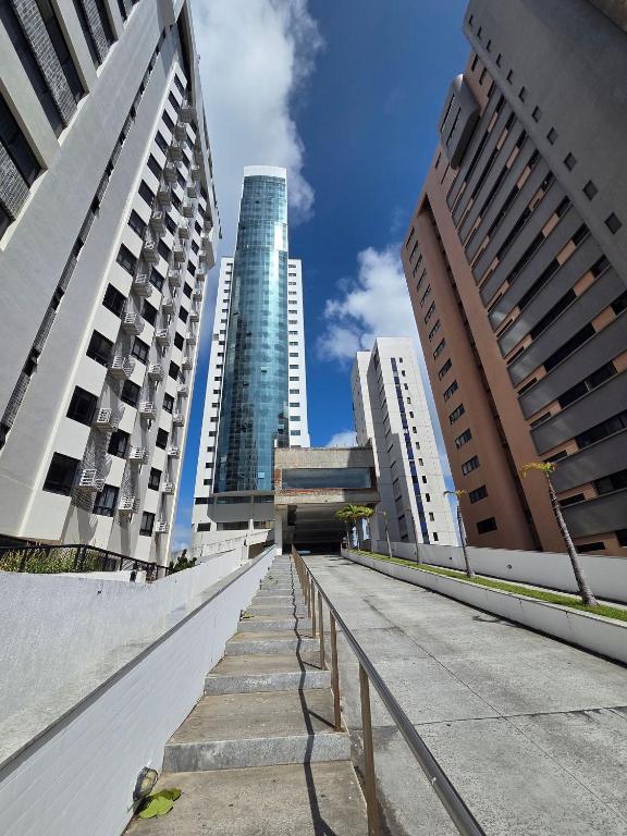 a walkway in a city with tall buildings at Beach Class Executive - Flats no Pina por Yolo in Recife