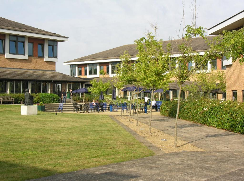 a group of trees in a yard in front of a building at Kents Hill Park Training & Conference Centre in Milton Keynes