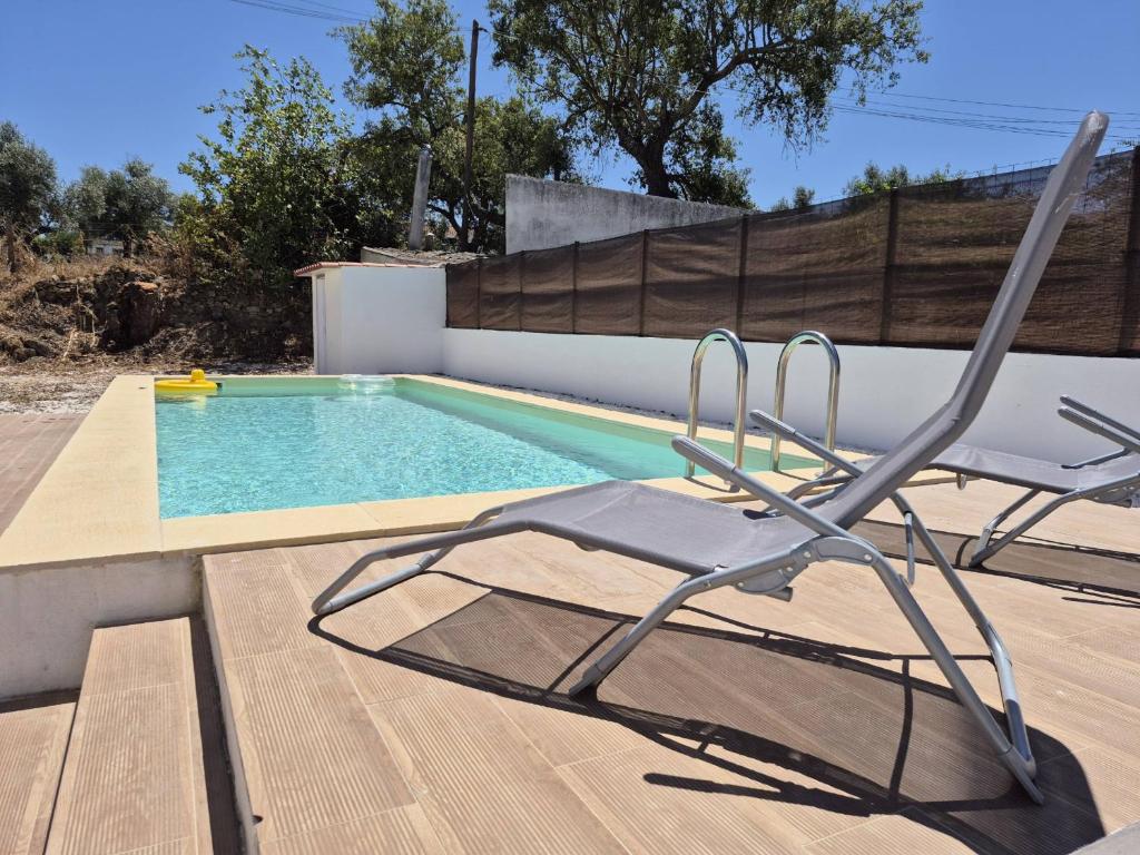 a chair sitting next to a swimming pool at Luar de Prata by Portus Alacer in Crato