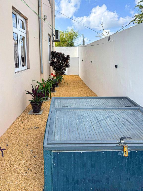 a blue chest sitting outside of a building at Bonzour Tropical Apartments l 2 Bedrooms l Pool l Equipped kitchen l Cosy l Trou aux Biches l Mauritius in Trou aux Biches