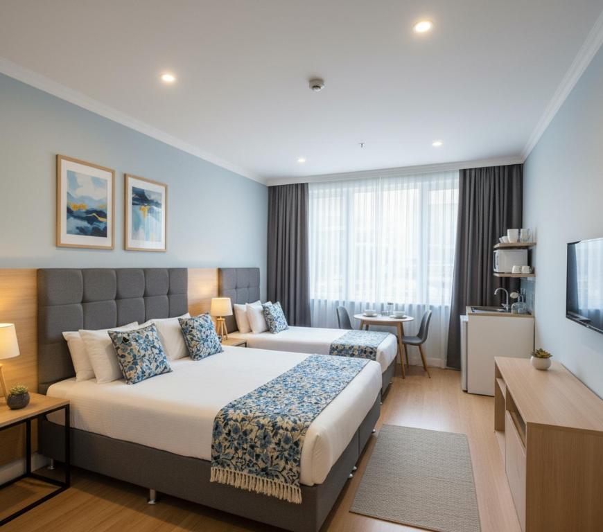 a hotel room with two beds and a television at Vera Arsuz in Arsuz
