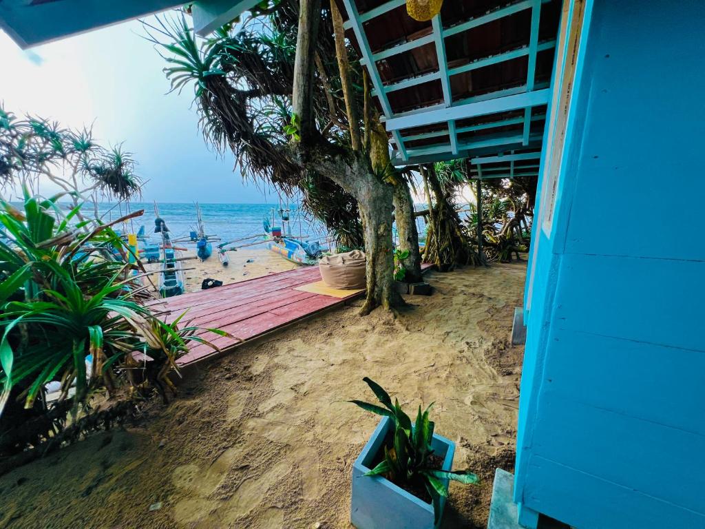 a view of a beach with a wooden deck at Ayaan Beach Home in Dodanduwa