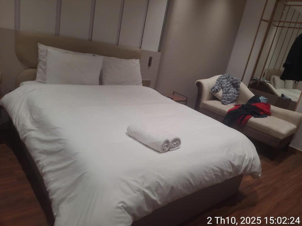 a large white bed with a pillow on top of it at Sulina Hlels 4 in Ho Chi Minh City
