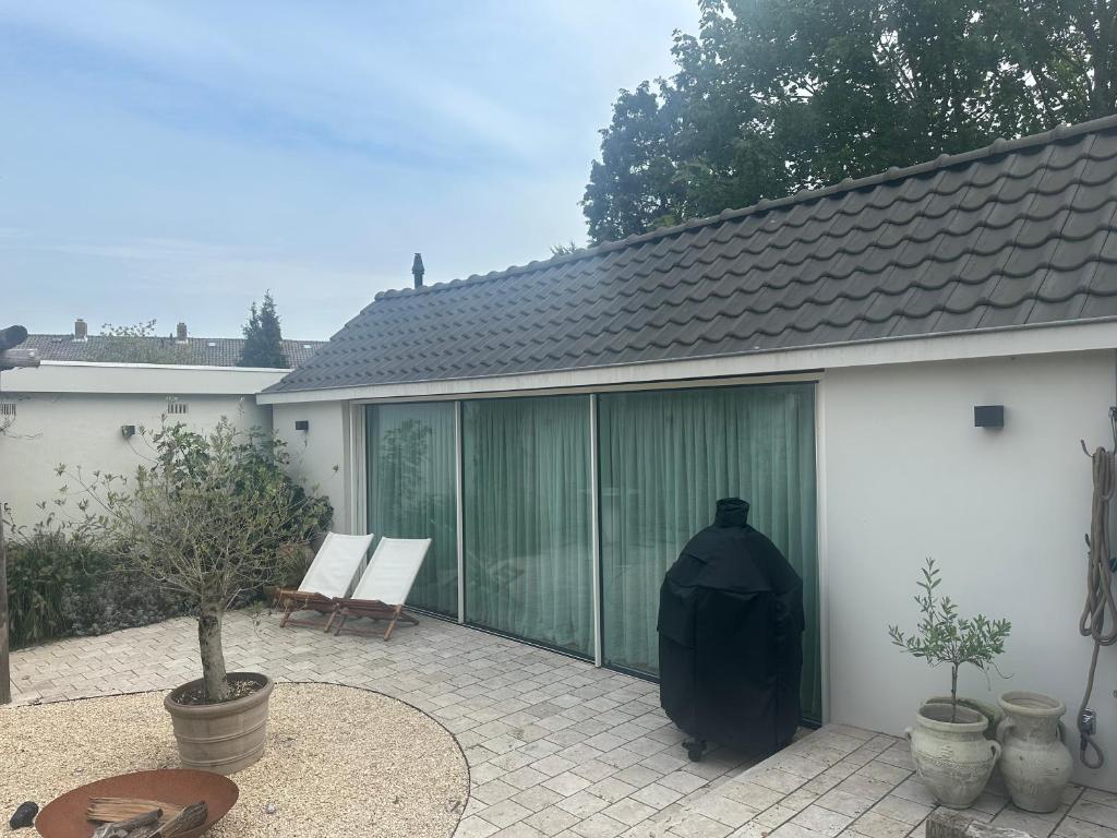 a patio with sliding glass doors on a house at Studio Cabana Oegstgeest in Oegstgeest