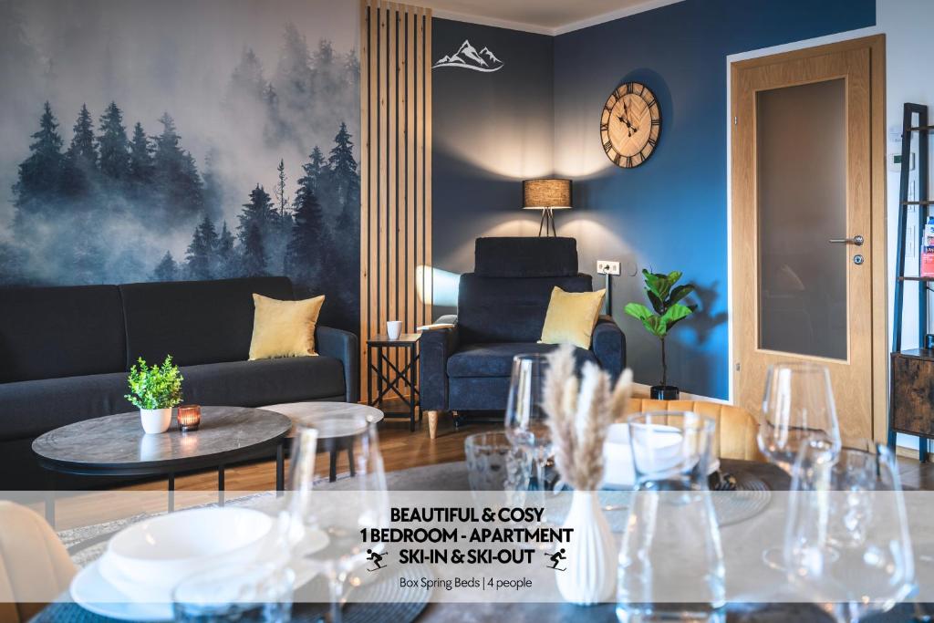 a living room with a couch and a table at ALPSTAY Eulennest - Ski-In & Ski-Out in Bad Kleinkirchheim