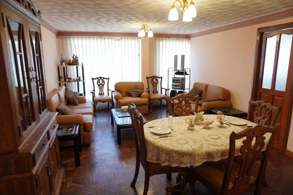 a living room with a table and chairs at La Paz Home in La Paz