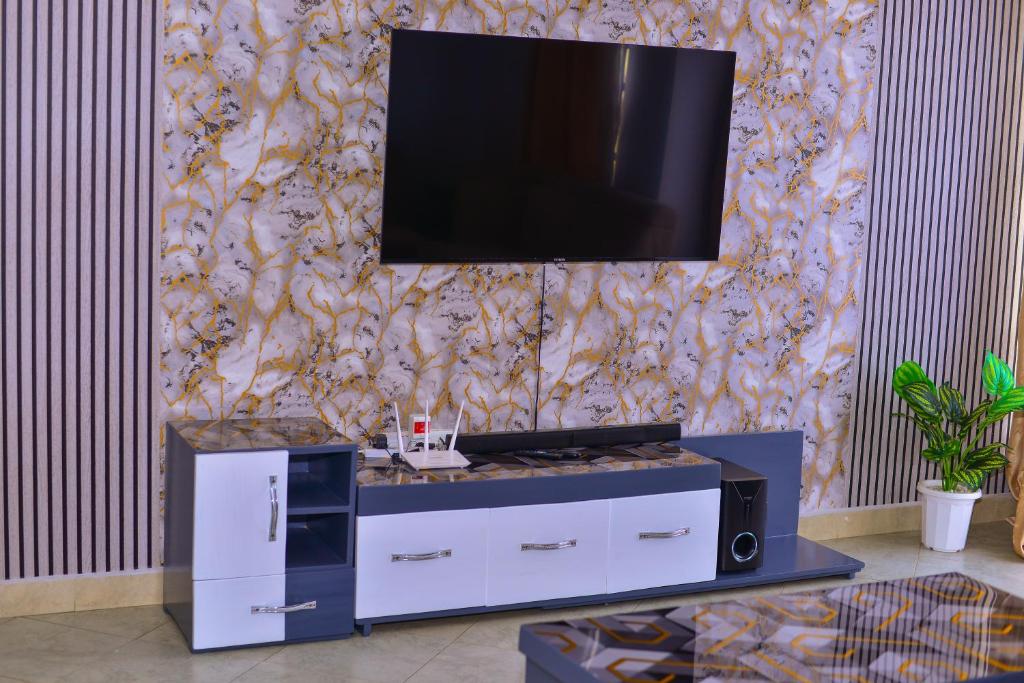 a living room with a tv on a wall at Haven Homes in Nakuru