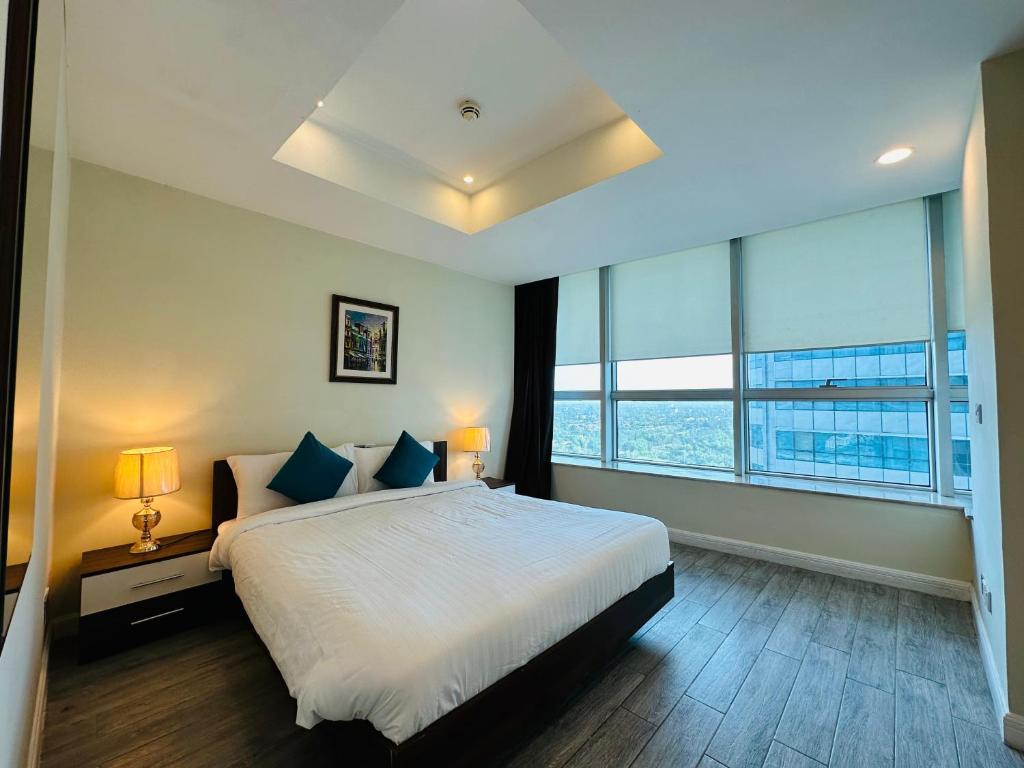 a bedroom with a large bed and a large window at Mountain View Luxury Centaurus Mall Apartment Islamabad in Islamabad