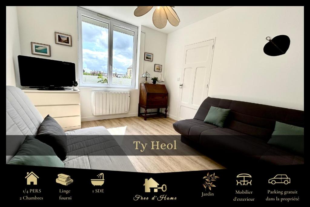 a bedroom with a couch and a tv in it at Ty Heol, maison authentique, lumineuse avec jardin in Saint-Caradec-Trégomel
