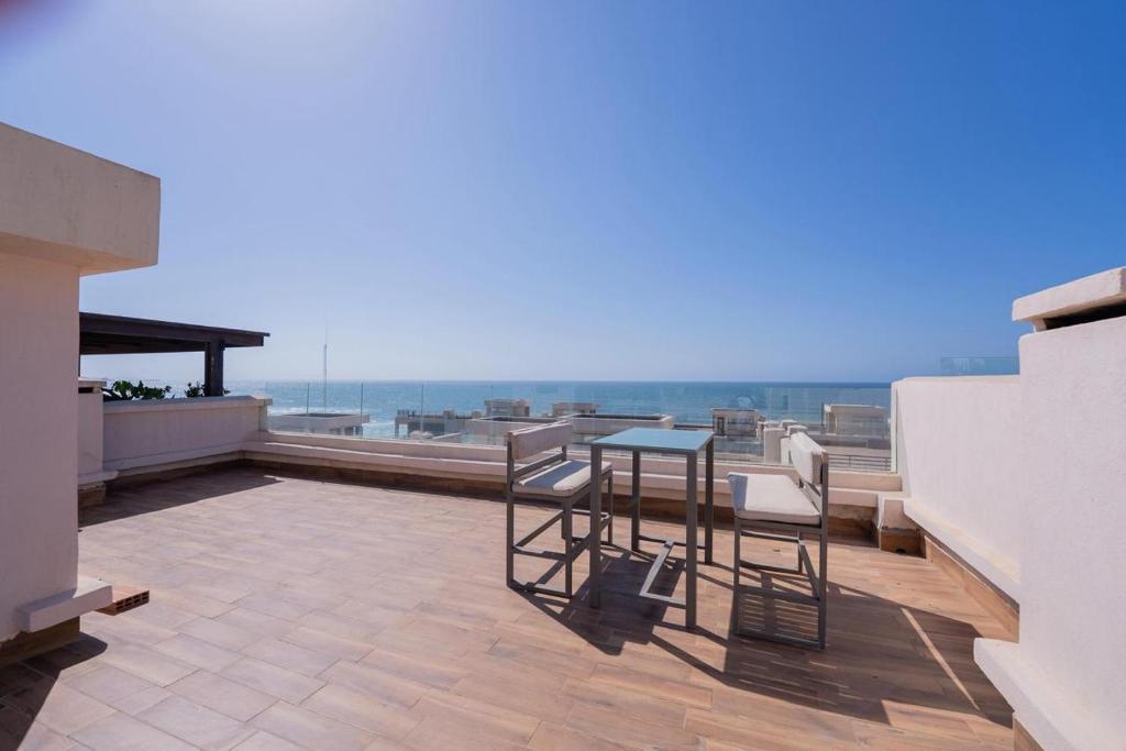 a patio with a table and chairs on a balcony at Jack Beach Bay in Tamaris