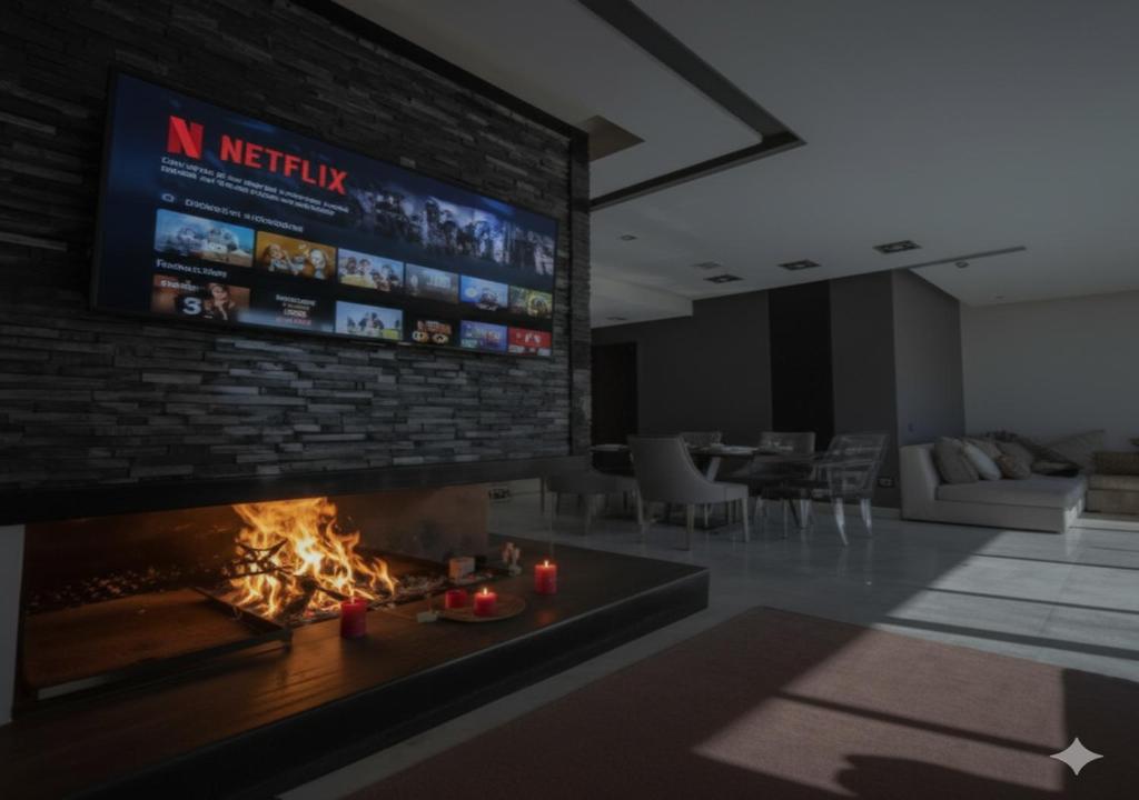 a living room with a fireplace and a large tv at Luxury Stay in Prestigia Golf City in Bouskoura