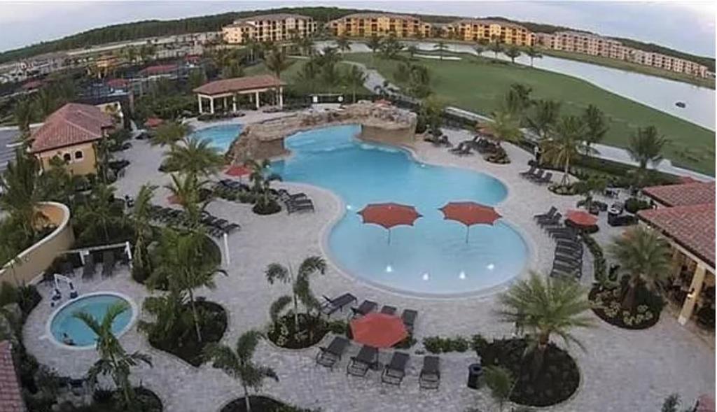an aerial view of a pool at a resort at Sunny First-Floor Condo in Bonita National with Golf & Social Membership Ideal 30-Night Stay in Bonita Springs
