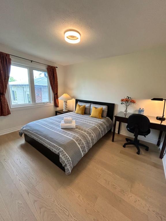 a bedroom with a bed and a desk with a desk at Super Cosy Peaceful room with Garden view free Parking in Toronto