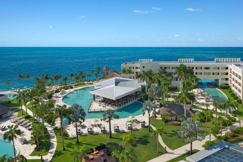 an aerial view of the resort with the ocean in the background at Dreams Puerto Morelos Resort & Spa - All Inclusive in Puerto Morelos