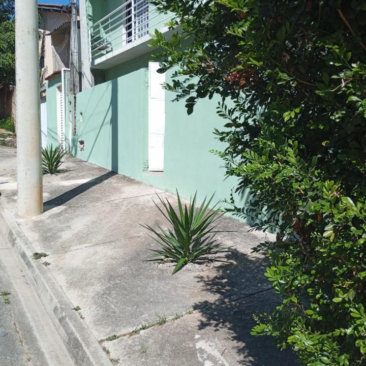 a blue building with plants on the side of a street at Hostel São Francisco 3 in Votorantim