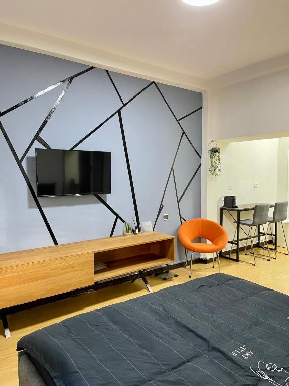 a bedroom with a flat screen tv on a wall at Bat Galim BEACH- Mirror apartment in Haifa