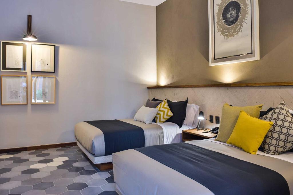 Postel nebo postele na pokoji v ubytování Hotel Criol