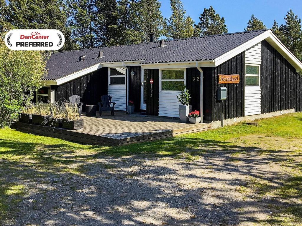 a building with a porch and a deck at 10 person holiday home in Jerup-By Traum in Jerup