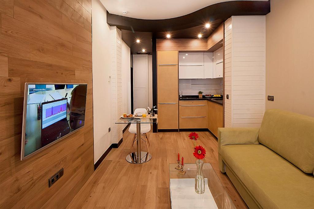 Televízia a/alebo spoločenská miestnosť v ubytovaní Apartamentos Suites Oficentro Deluxe
