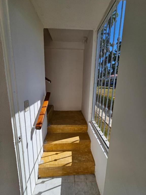 a room with a staircase with a bench and a window at Departamento El Dorado in Barrio Nuevo