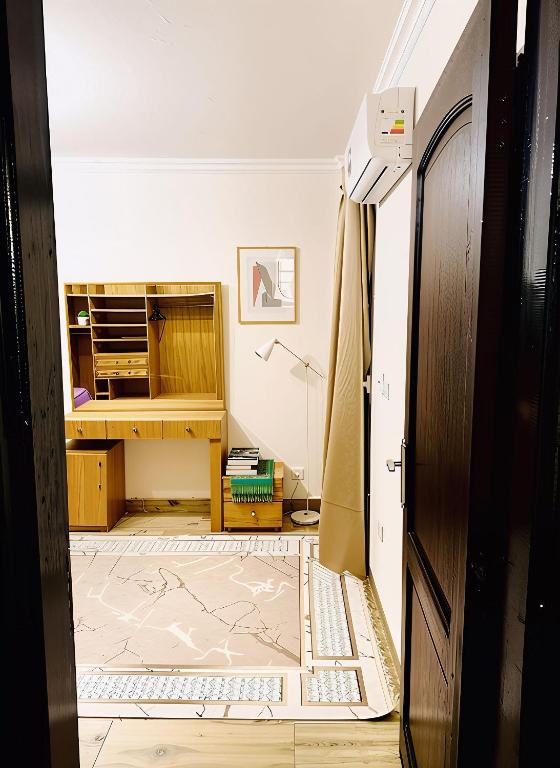 a hallway with a room with a desk and a bed at 2Bedroom Apartment and Living Room at Shiekh Zayed in Sheikh Zayed