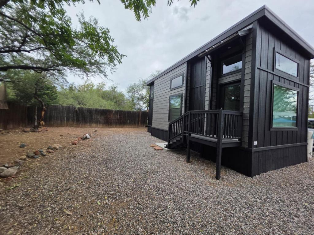 a black tiny house sitting on top of a gravel yard at Luxurious Tiny Home 15 Minutes from Sedona! #25 in Cottonwood