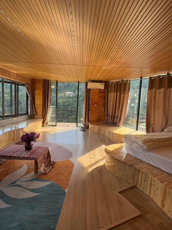 a room with two beds and a large window at Sapawine Homestay in Sapa