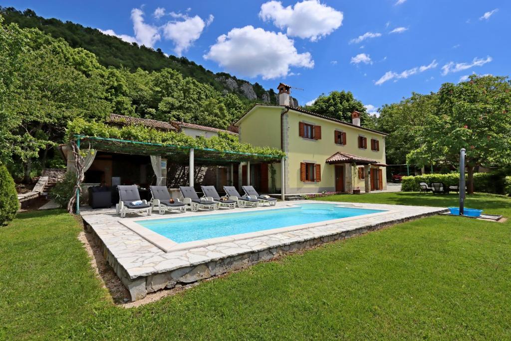 an external view of a villa with a swimming pool at Family friendly house with a swimming pool Dolenja Vas, Central Istria - Sredisnja Istra - 24521 in Dolenja Vas