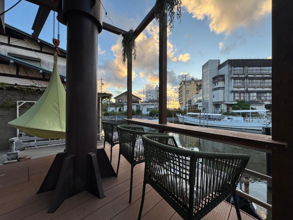 Un balcón con sillas y vista a un río. en UMI&kanzanji, en Hamamatsu