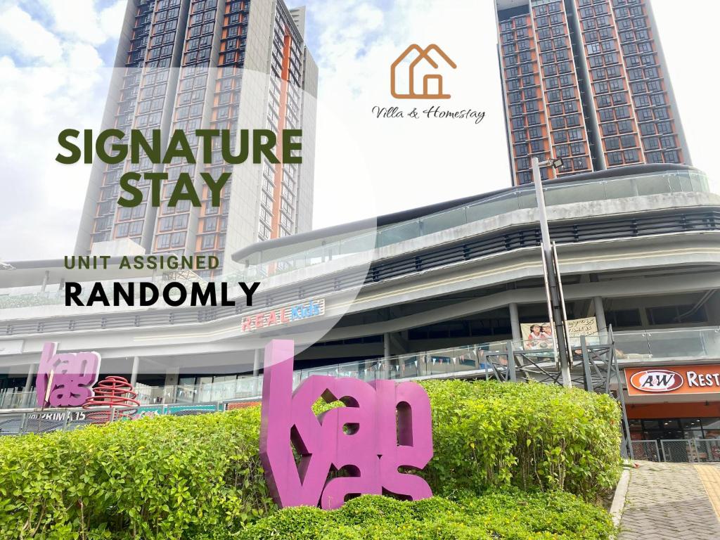 a sign in front of a building with tall buildings at ImpianKU at KANVAS SOHO Cyberjaya in Cyberjaya