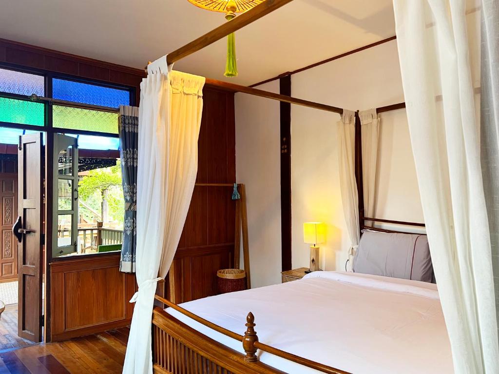 Ένα ή περισσότερα κρεβάτια σε δωμάτιο στο Pao Come Boutique House