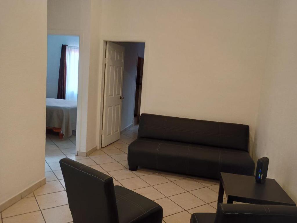 a living room with a couch and a table at Casa a una cuadra de la playa in Ensenada