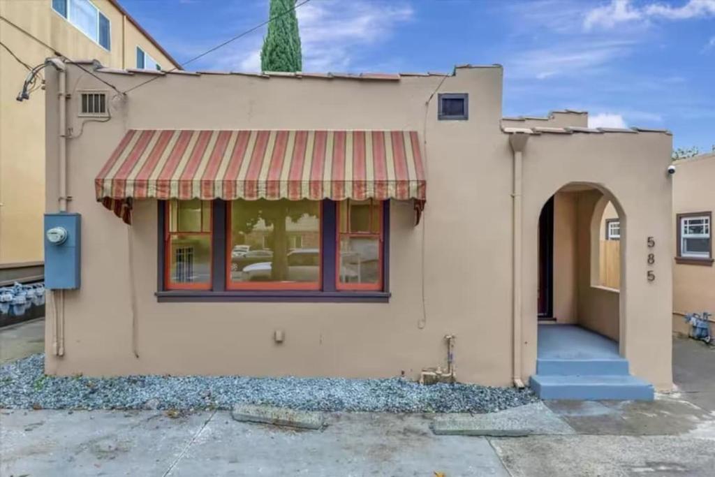 een huis met een rode luifel aan de voorkant bij Iconic 2BR Bungalow, Short Walk to SJSU, with Parking in San Jose