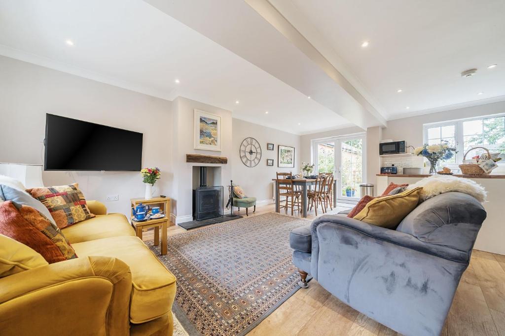 a living room with two couches and a tv at Orchard House Docking in Docking