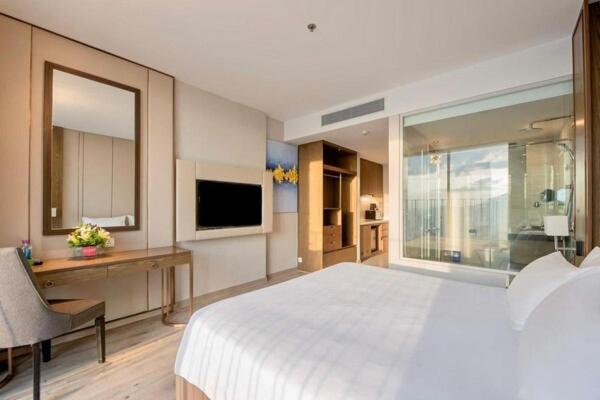 Giường trong phòng chung tại Winsgroup - Suites Panorama Grand