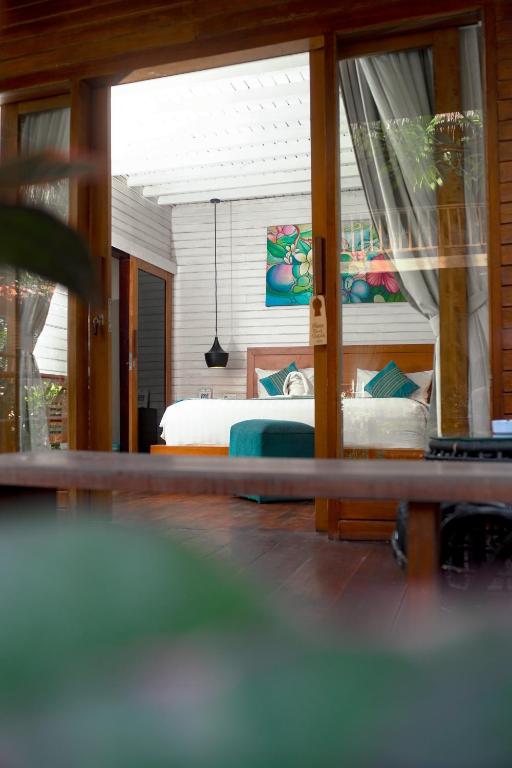 a view of a bedroom with a bed and a window at Sadev Resort in Gili Trawangan