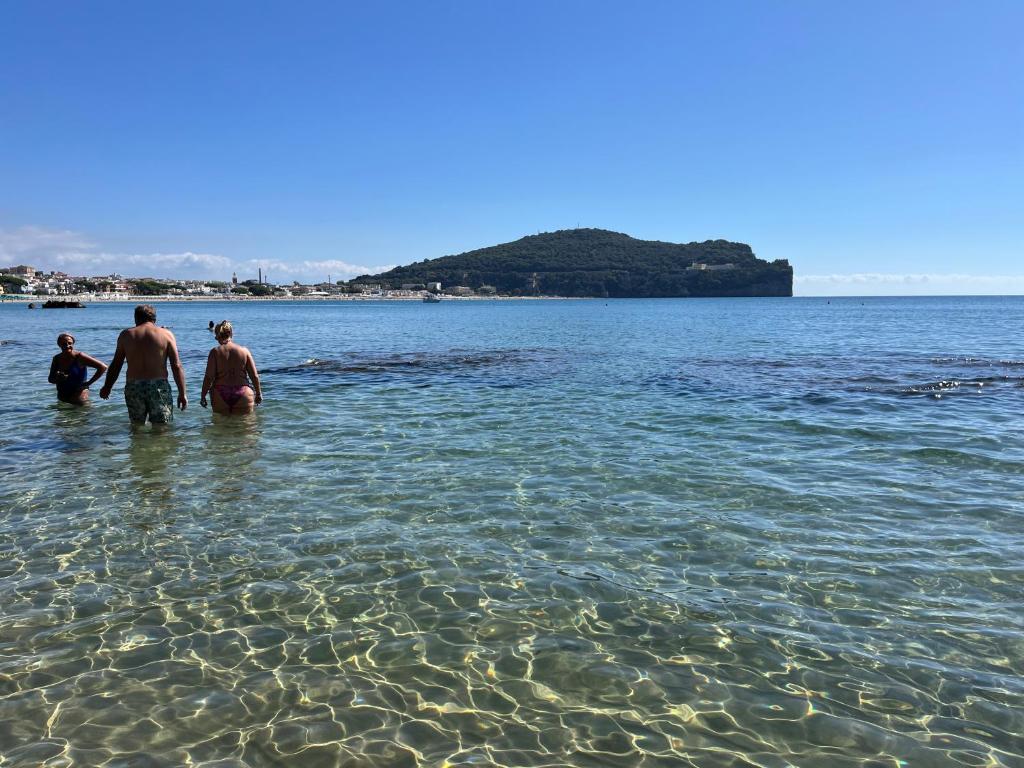 a group of three people standing in the water at MAREMONTI alloggio turistico in Formia